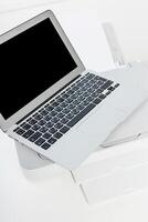 Laptop on a printer in a modern office setting with minimalistic design during daytime photo