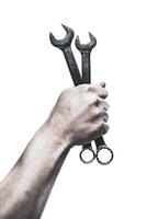 Hand holds two wrenches demonstrating tool usage for repairing machinery or equipment photo