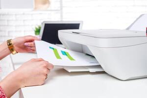 Printing documents in a modern office setup with a minimalist design during daytime hours photo