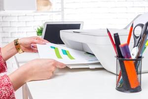 Printing a colorful document on a modern printer in a bright office space photo