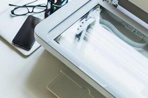 Scanner and office supplies on a work desk during a busy day focused on productivity and organization photo