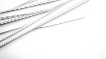 A collection of white sheets of paper arranged at an angle on a clean surface, ideal for backgrounds photo