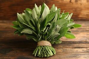 Fresh sage leaves arranged on rustic wooden table. photo