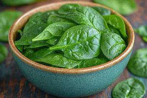 Fresh spinach leaves in rustic bowl display photo