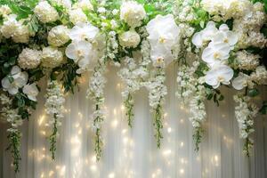Beautiful white orchids and hydrangeas hanging over sheer curtain backdrop creating elegant wedding decoration photo