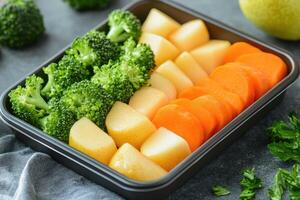 Freshly prepared vegetables in meal prep container photo
