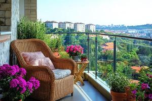 Wicker armchair inviting to relax on balcony overlooking city on sunny summer day photo