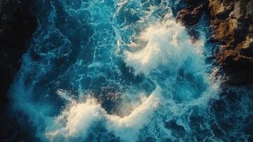 Powerful ocean waves crashing against rocky cliff, a breathtaking aerial view of nature's fury. photo