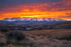 Sunrise painting the Sawtooth Mountains in Stanley, Idaho, in orange and red photo