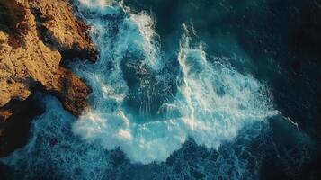 Powerful ocean waves crashing against rocky cliff, a breathtaking aerial view of nature's fury.. photo