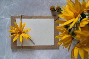 A gift card with yellow flowers on a sunny day for Mother's Day. Space for text. photo