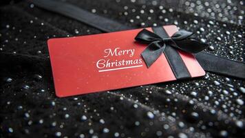Red Merry Christmas Gift Card on Black Sparkling Background photo
