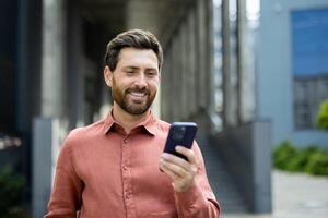 Successful man with phone in hands close up, employee browsing social networks and typing text message. Businessman using app to analyze financial indicators. photo