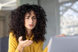 Dissatisfied and upset woman received a rejection and error while working with laptop. Businesswoman looking at computer screen close up, unhappy and sad. photo