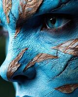Close up of a blue humanoid face with leaf like markings photo