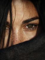 Close up of a woman's face with freckles and green eyes. photo