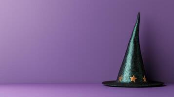 Sparkly green witch hat with gold stars on a purple background photo