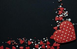 A red heart shaped cookie with white polka dots is the central focus of the image photo