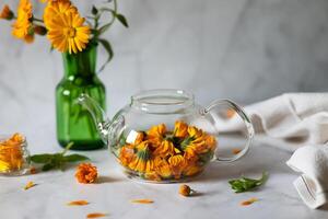 A teapot with calendula. Prevention of diseases. Antivirus on a sunny day photo
