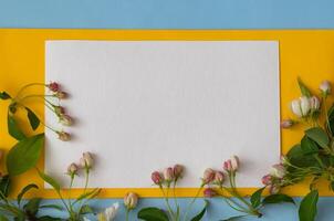 A blank card set amongst flowers, tied with a ribbon, hints at a thoughtful message and an occasion for heartfelt expression. photo