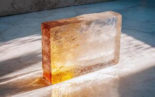 A block of crystal salt on a marble surface with light and shadow photo