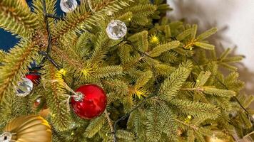 Festive close up of a decorated Christmas tree with colorful baubles and twinkling lights, symbolizing holiday cheer and celebration photo