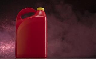 Front view of red plastic motor oil bottle, container with handle and yellow screw cap without label against dark background photo