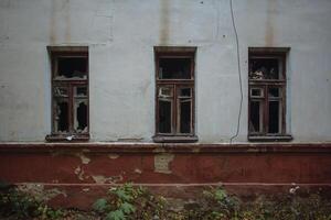 Broken windows of abandoned building photo