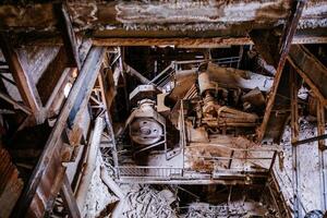 Old broken empty abandoned factory with rusty machines photo