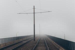 Foggy railway bridge, railroad tracks photo