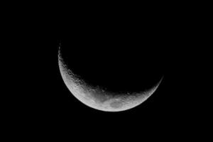 The moon is seen in black and white photo