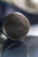 A microphone on a table with a reflection photo