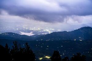 A view of a city and mountains at night photo