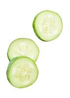 A set of fresh green cucumber slices in circle shape in stack isolated on white background with clipping path photo
