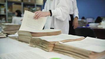 Office Workers Sorting printed Documents video