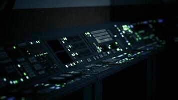 A dimly lit sci fi laboratory features an array of glowing control panels video
