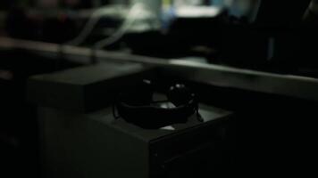A pair of sunglasses resting on a table in a dimly lit room video