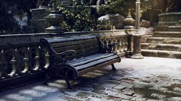 Empty bench covered in snow in a serene winter garden setting video