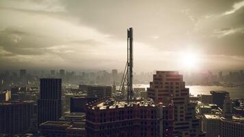Sunset over a sprawling city skyline with a communication tower in view video