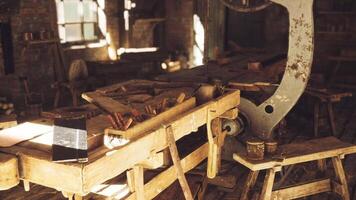 Crafting tools and old machinery in a rustic workshop filled with sunlight video