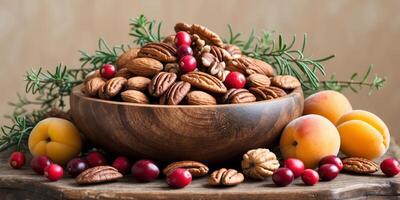 Nut mix in wooden bowl with cranberries apricots on beige background cozy snack setting. photo