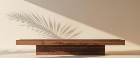 Wooden podium with palm leaf shadow on beige background for product presentation. photo