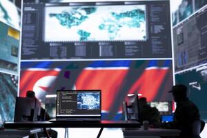 Army soldiers working in a control center base of operations with a North Korea flag on big screen, monitoring footage via gps location and world map. Staff committing war crimes against rivals. photo