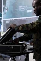 IT expert soldier collecting real time satellite radar data in command post, processing intelligence and coordinating strategic operations to ensure national defense missions. Secret service tower. photo