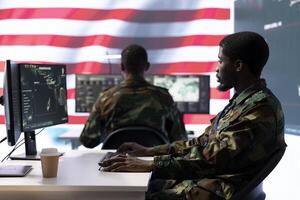 Intelligence officers in american military uniforms work on computers in a command post, managing surveillance and data analysis. Support global operations for the US government. photo