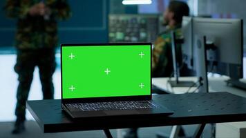 Military officer leads cybersecurity operations in a high tech operation room command post, ensuring data protection. Soldiers working with cctv surveillance systems, satellite imagery. Camera A. photo