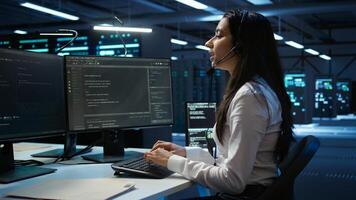 Data center call center agent responsible for providing logistics support to businesses. Worker in server farm establishment oversees infrastructure systems and communicates with engineers, camera B photo