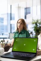 Recruiter using green screen laptop doing interview with person after finding best talent to fill open company position. HR department employee using chroma key notebook, finalizing deal with man photo