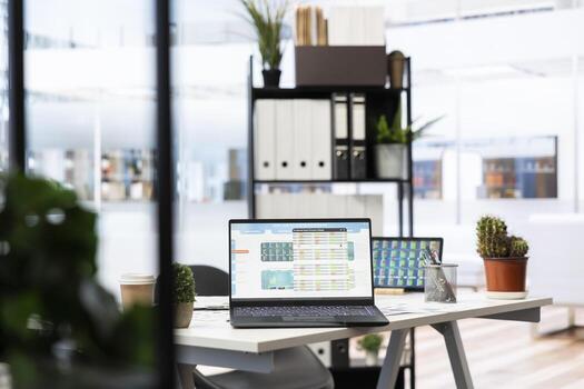 Empty company financial department with stock portfolio on laptops containing collection of investment assets. Workspace with live index indices on notebook screen showing stock demand surge photo