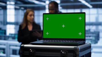 Isolated screen laptop in data center running error checking software monitoring hardware bugs. Close up of mockup notebook in server hub workspace checking for network issues, camera A photo